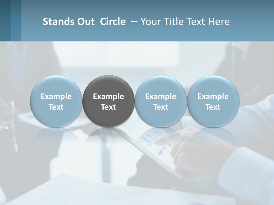 A Group Of People Sitting Around A Table With A Tablet PowerPoint Template