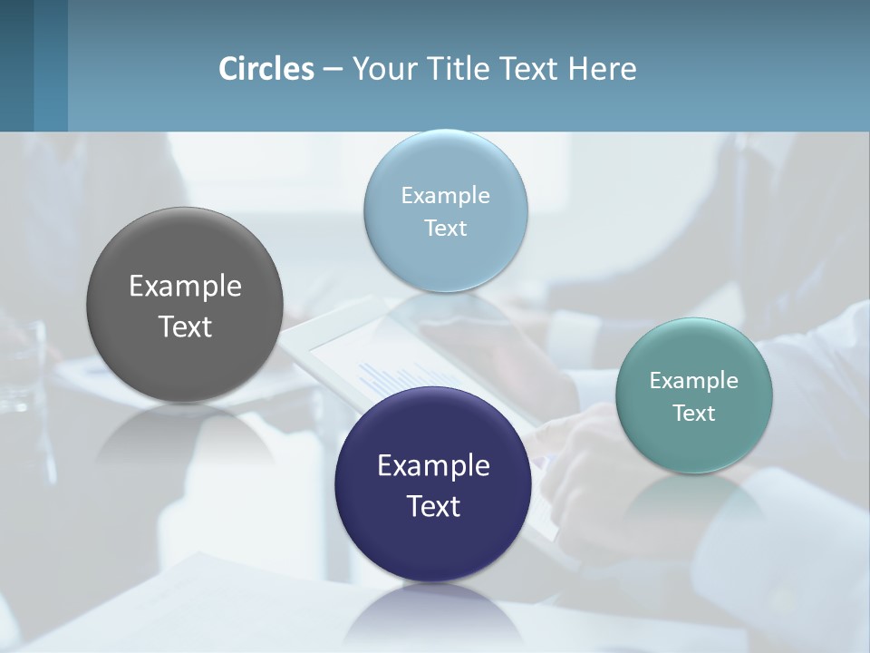 A Group Of People Sitting Around A Table With A Tablet PowerPoint Template