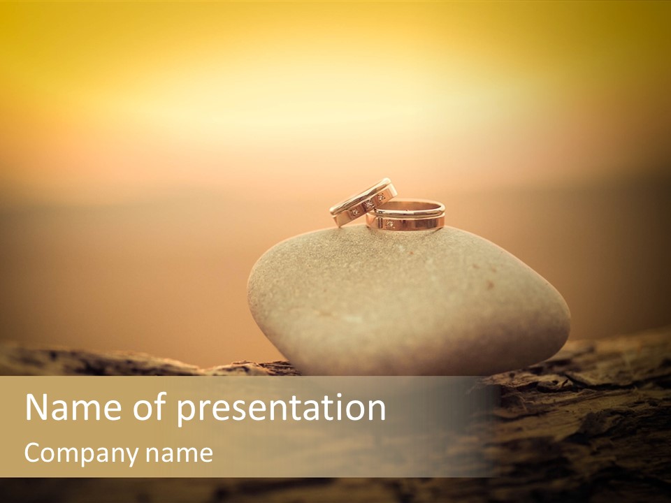 Two Wedding Rings Sitting On Top Of A Rock PowerPoint Template