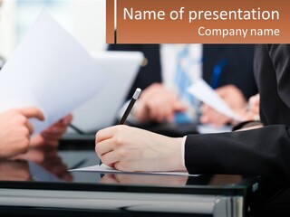 A Group Of People Writing On A Piece Of Paper PowerPoint Template