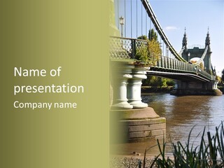 A Bridge Over A Body Of Water With A Building In The Background PowerPoint Template