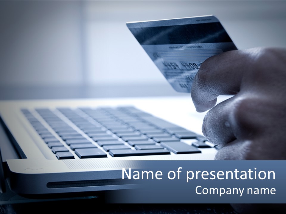 A Person Holding A Credit Card In Front Of A Laptop PowerPoint Template