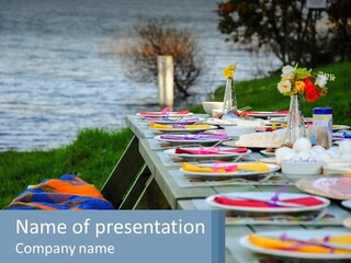 A Long Table With Plates On It With A Lake In The Background PowerPoint Template