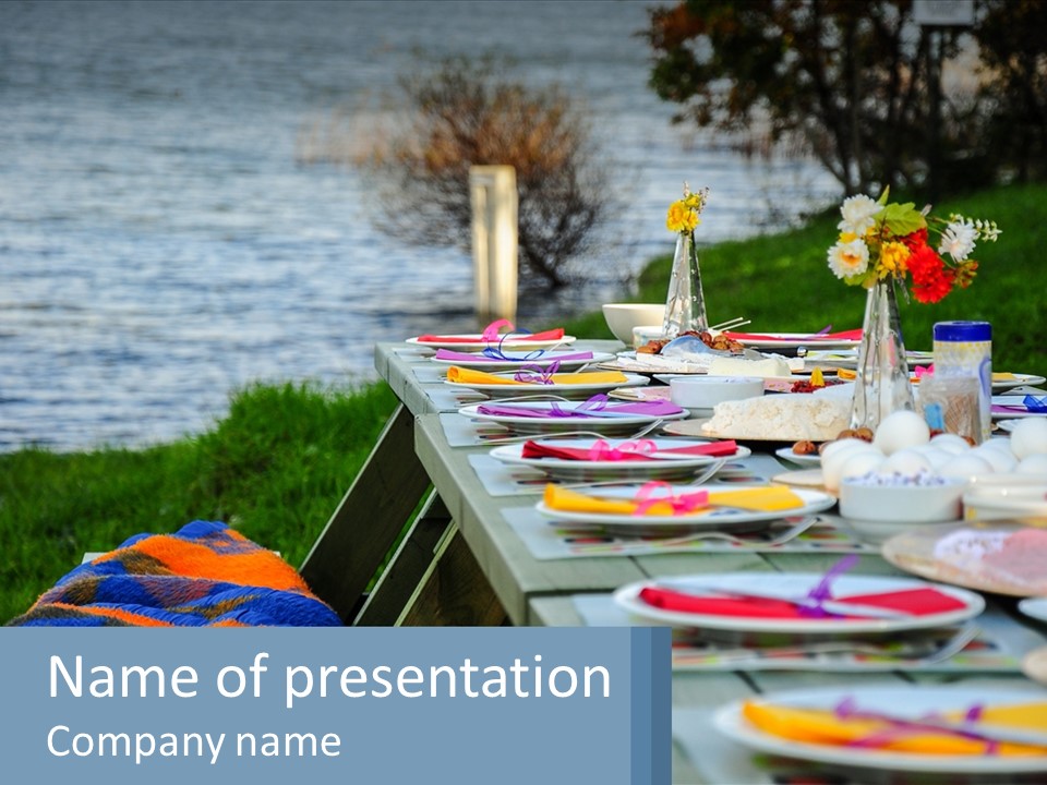 A Long Table With Plates On It With A Lake In The Background PowerPoint Template
