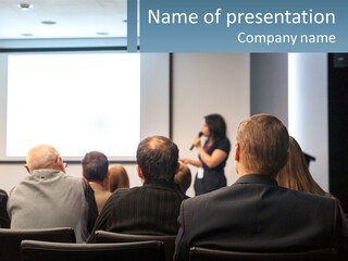 A Woman Giving A Presentation To A Group Of People PowerPoint Template