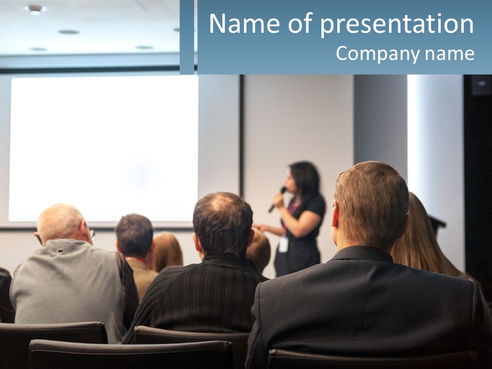 A Woman Giving A Presentation To A Group Of People PowerPoint Template