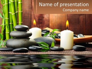 A Table Topped With Rocks And Candles Next To Bamboo PowerPoint Template