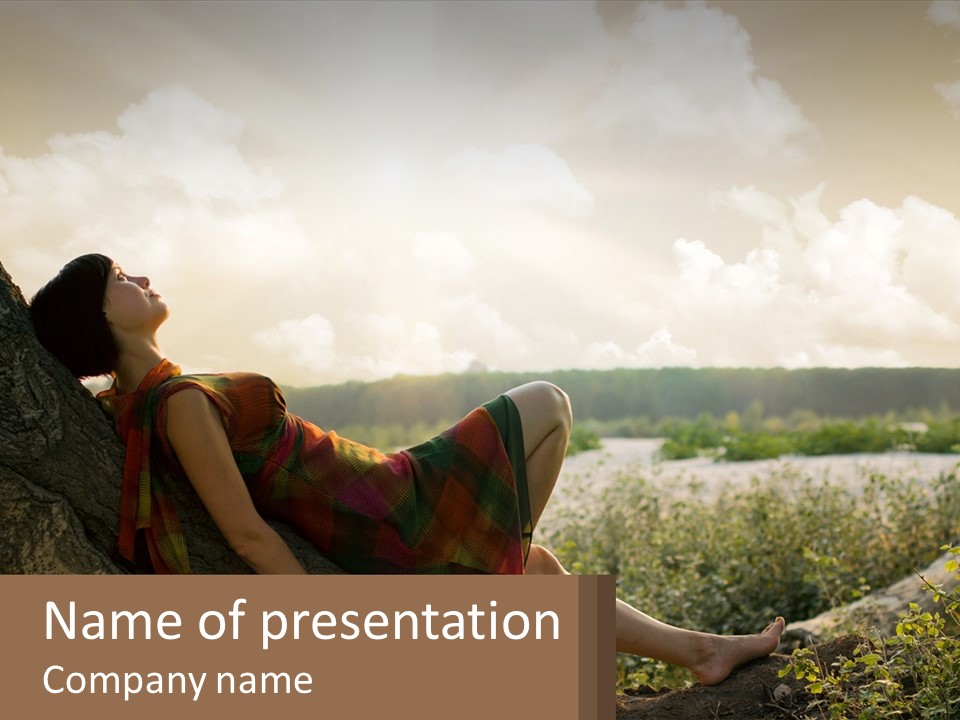 A Woman Sitting On A Tree In A Field PowerPoint Template