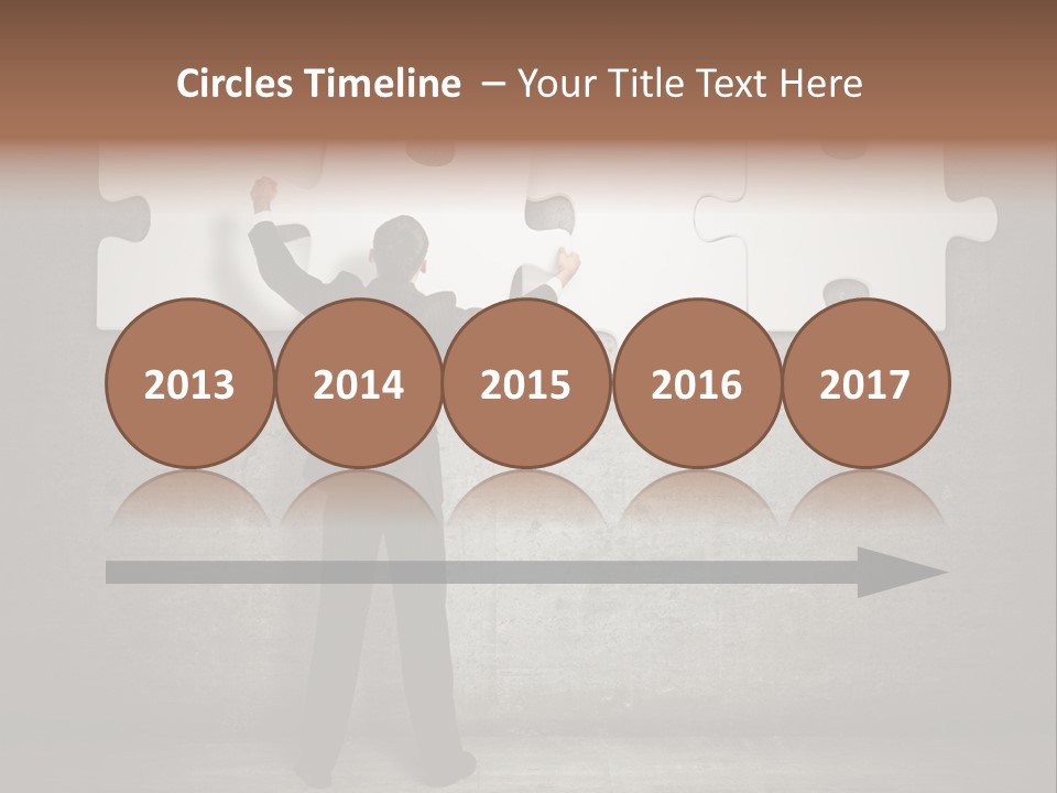 A Man In A Suit Holding A Puzzle Piece PowerPoint Template