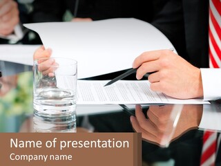 A Man In A Suit Writing On A Piece Of Paper PowerPoint Template