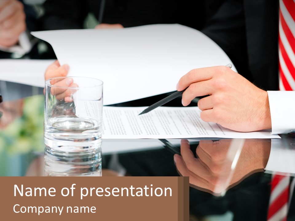 A Man In A Suit Writing On A Piece Of Paper PowerPoint Template