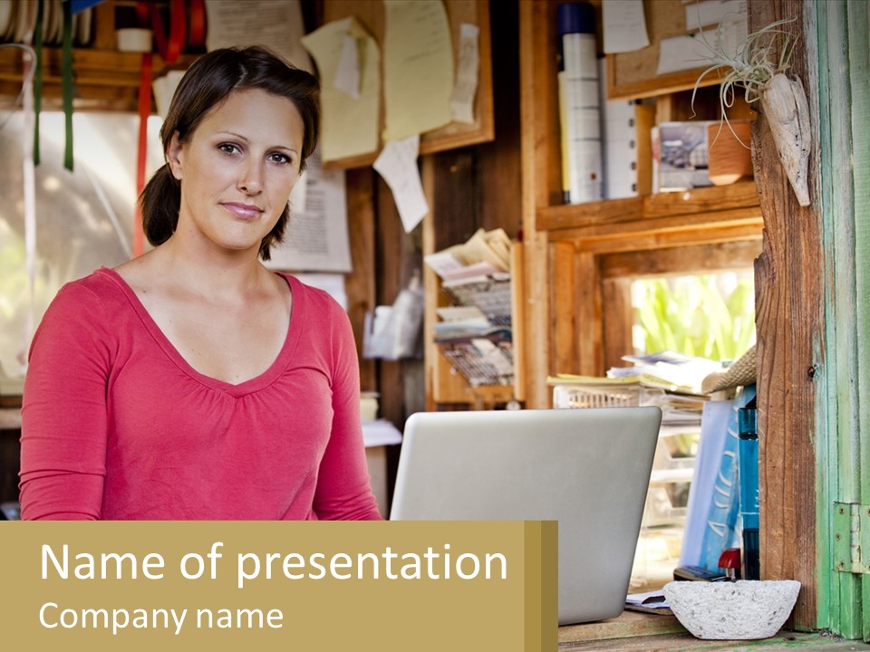 A Woman Sitting In Front Of A Laptop Computer PowerPoint Template
