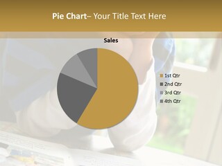 A Young Boy Reading A Book On Top Of A Table PowerPoint Template