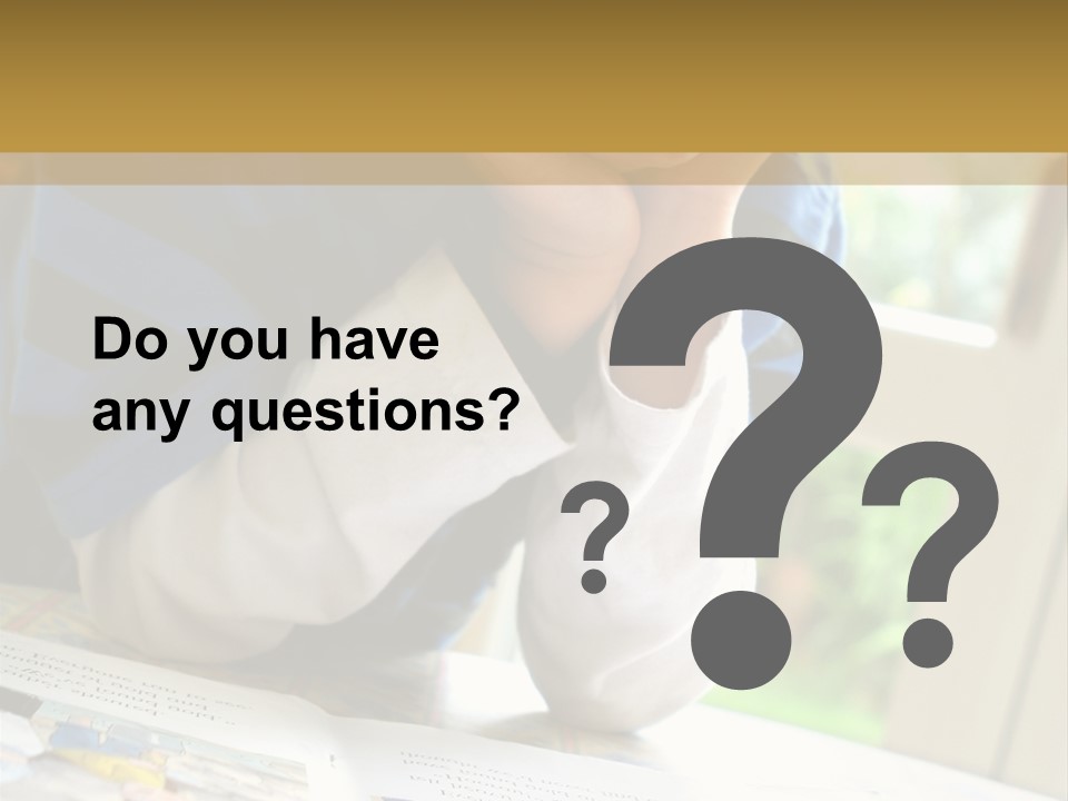 A Young Boy Reading A Book On Top Of A Table PowerPoint Template