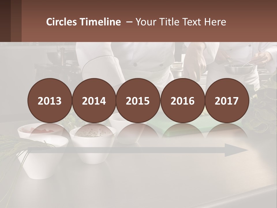 A Group Of Chefs Preparing Food In A Kitchen PowerPoint Template