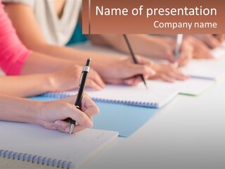 A Group Of People Sitting At A Table Writing On Notebooks PowerPoint Template
