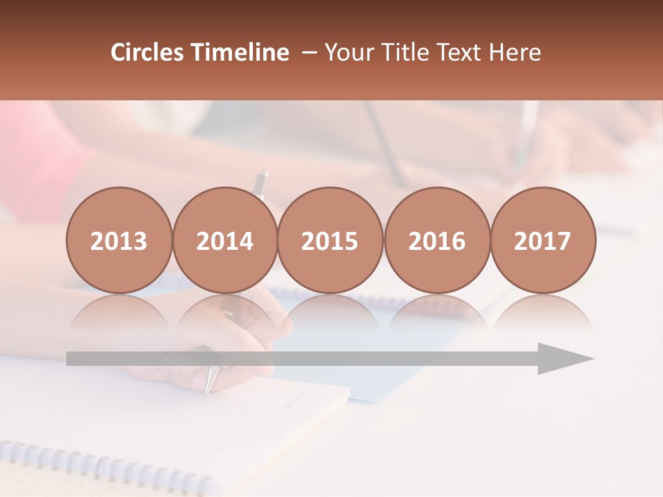 A Group Of People Sitting At A Table Writing On Notebooks PowerPoint Template