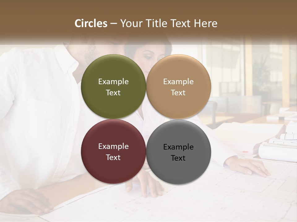 A Man And Woman Sitting At A Desk In An Office PowerPoint Template