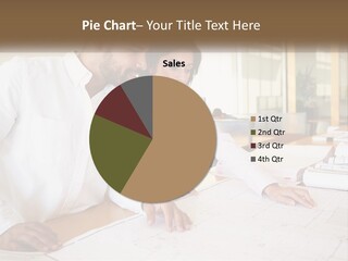 A Man And Woman Sitting At A Desk In An Office PowerPoint Template