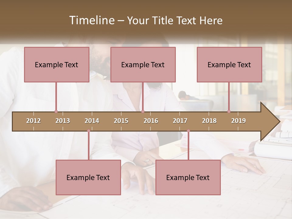 A Man And Woman Sitting At A Desk In An Office PowerPoint Template