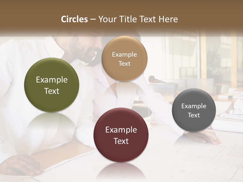 A Man And Woman Sitting At A Desk In An Office PowerPoint Template