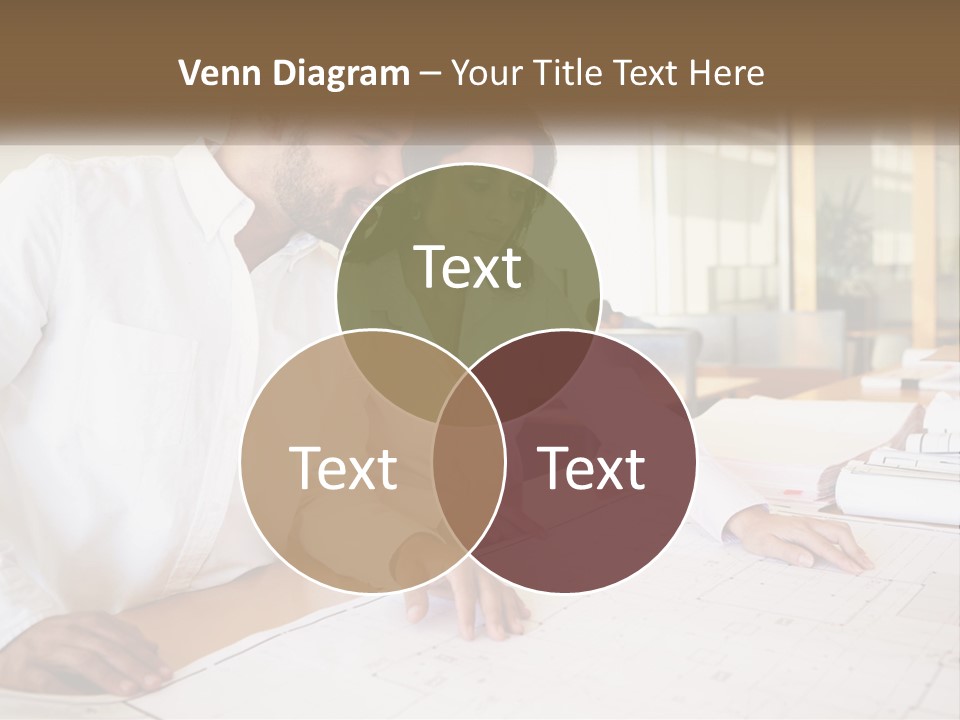 A Man And Woman Sitting At A Desk In An Office PowerPoint Template