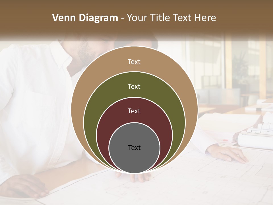 A Man And Woman Sitting At A Desk In An Office PowerPoint Template