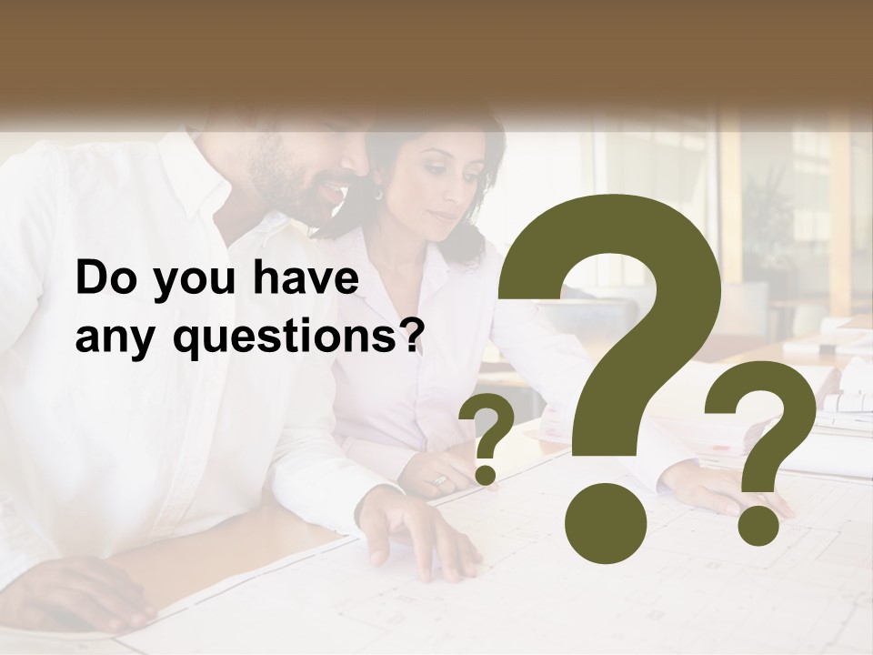 A Man And Woman Sitting At A Desk In An Office PowerPoint Template