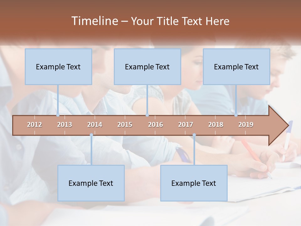 A Group Of People Sitting At A Table Writing PowerPoint Template