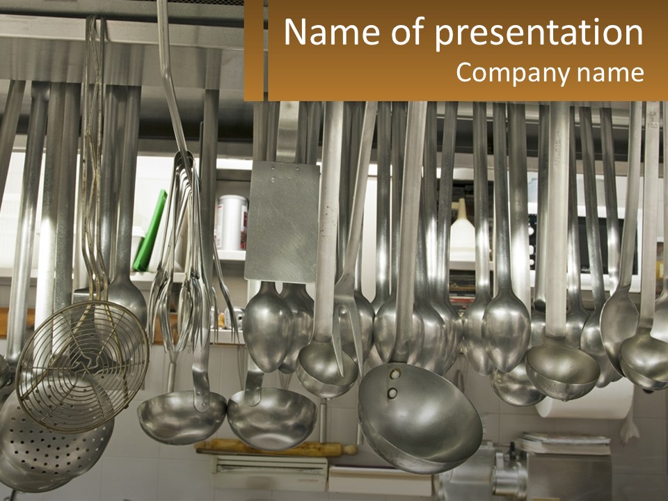 A Bunch Of Spoons Hanging From A Rack In A Kitchen PowerPoint Template