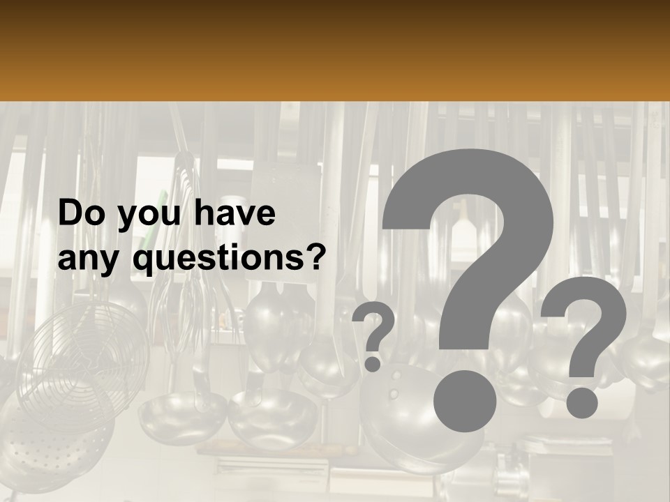 A Bunch Of Spoons Hanging From A Rack In A Kitchen PowerPoint Template