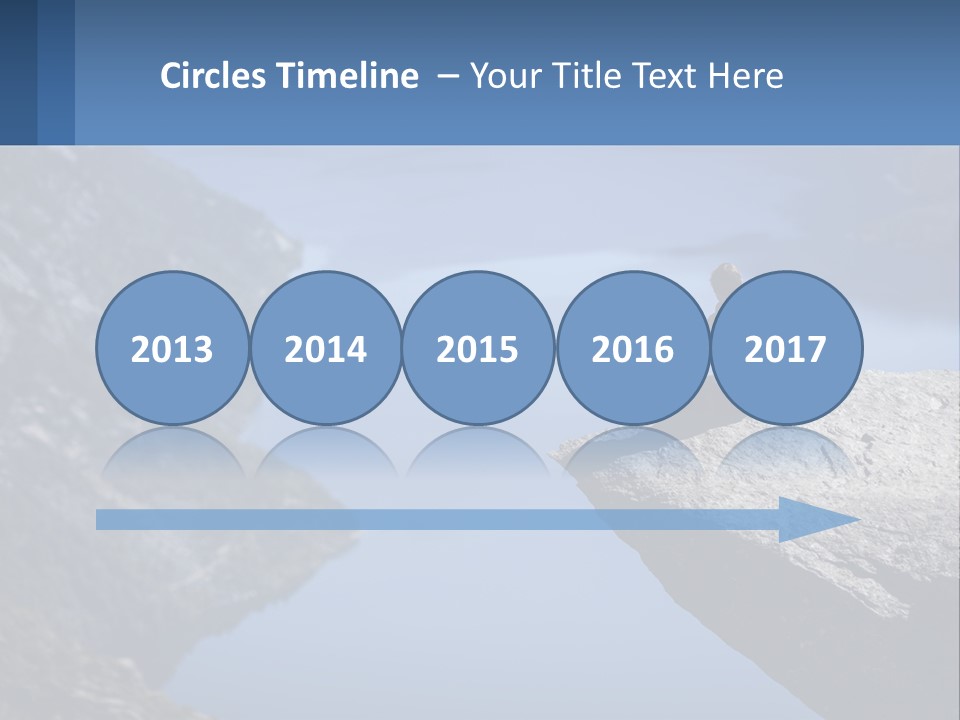 A Person Sitting On Top Of A Cliff Overlooking A Lake PowerPoint Template