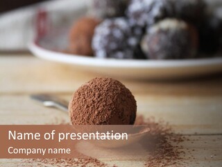 A Spoon Full Of Chocolate Powder Next To A Plate Of Chocolate Balls PowerPoint Template