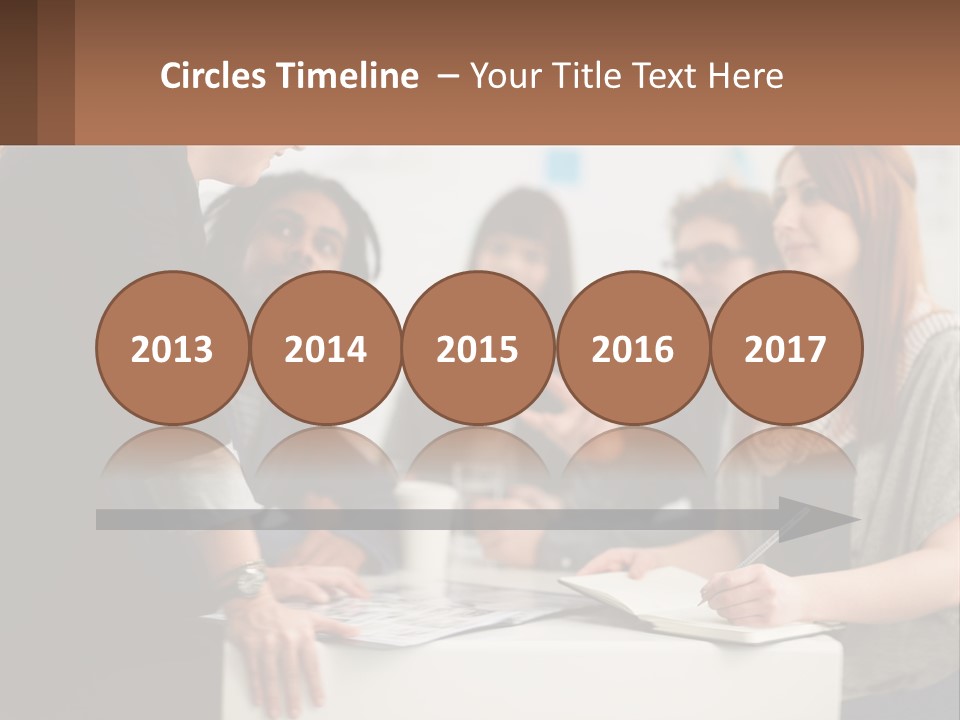 A Group Of People Sitting Around A Table Talking PowerPoint Template