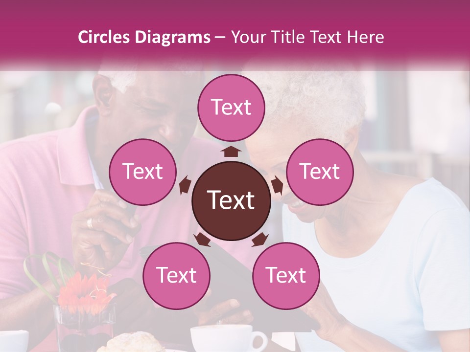 A Man And Woman Sitting At A Table Looking At A Tablet PowerPoint Template