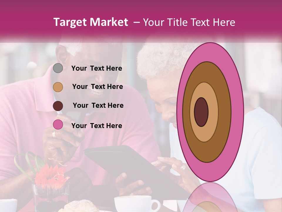 A Man And Woman Sitting At A Table Looking At A Tablet PowerPoint Template