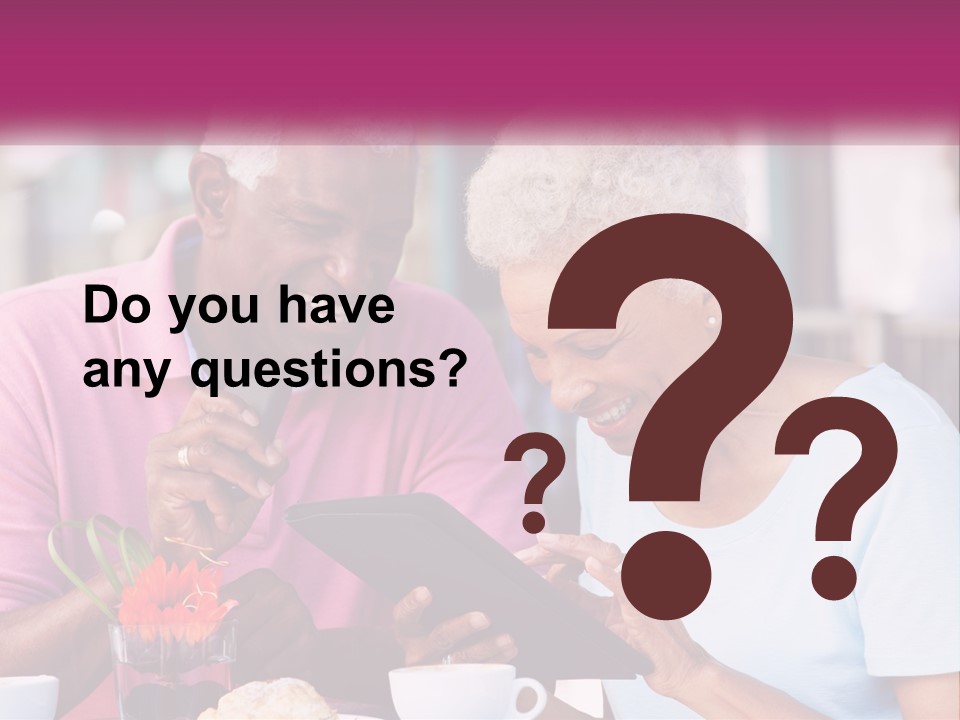 A Man And Woman Sitting At A Table Looking At A Tablet PowerPoint Template