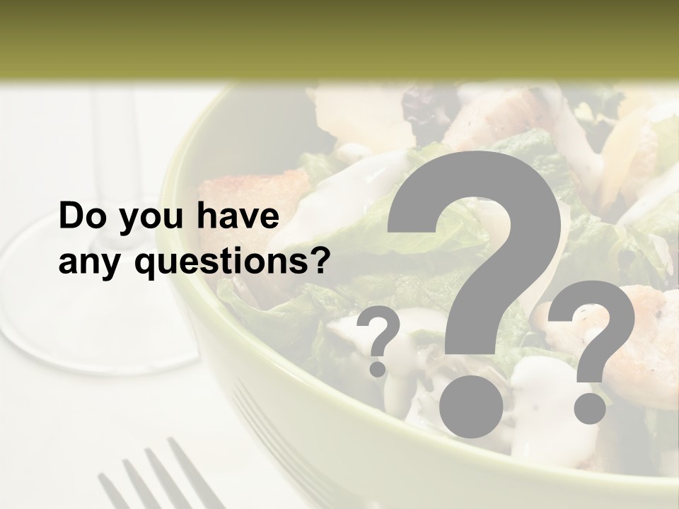 A Green Bowl Filled With Salad Next To A Glass Of Wine PowerPoint Template