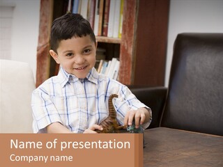 A Young Boy Sitting At A Table With A Toy PowerPoint Template