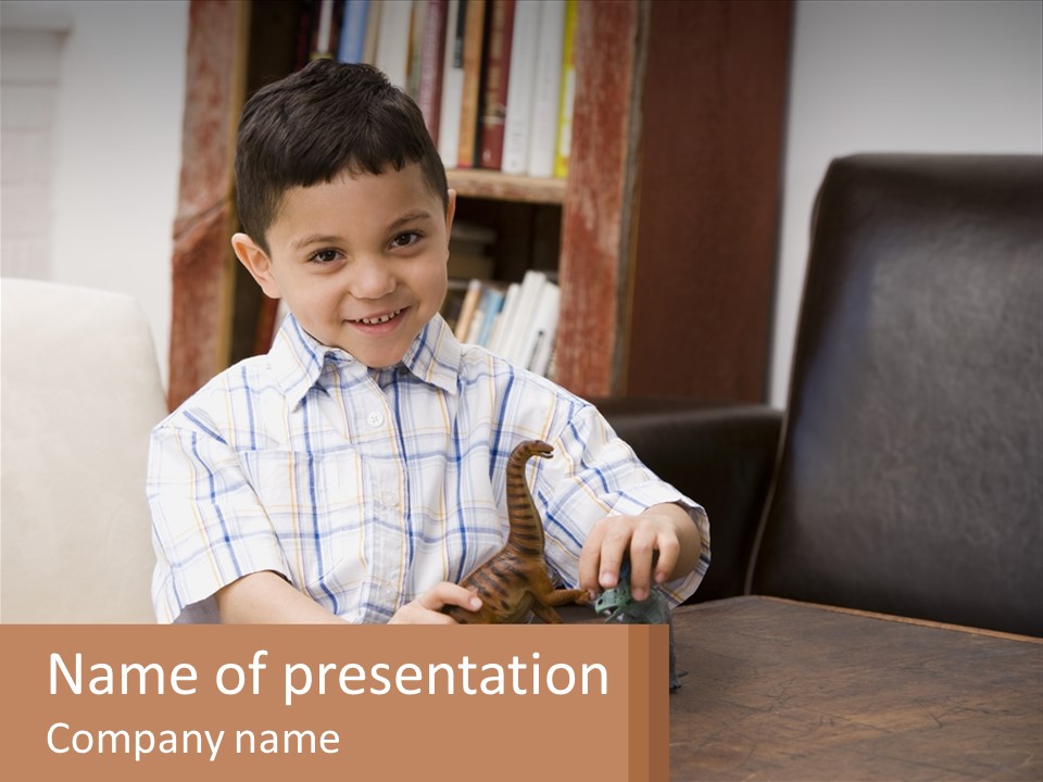 A Young Boy Sitting At A Table With A Toy PowerPoint Template