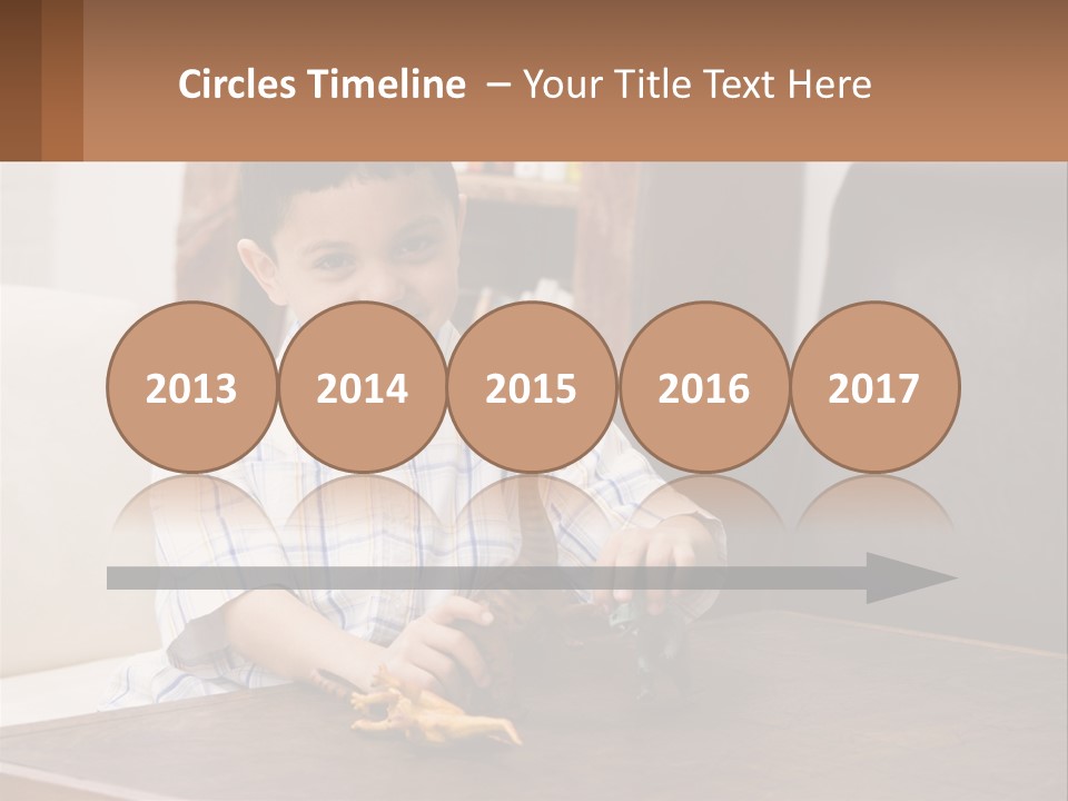 A Young Boy Sitting At A Table With A Toy PowerPoint Template
