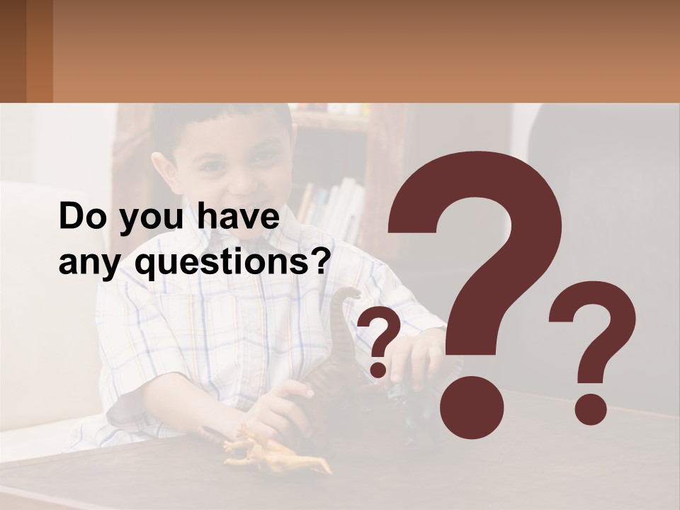 A Young Boy Sitting At A Table With A Toy PowerPoint Template