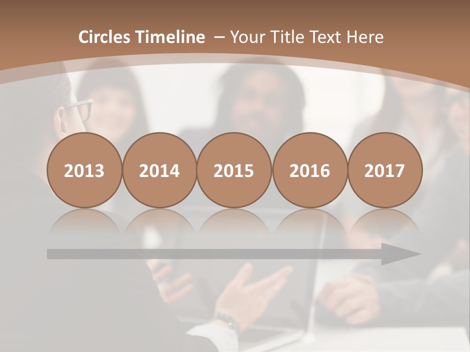 A Group Of People Sitting At A Table With A Laptop PowerPoint Template