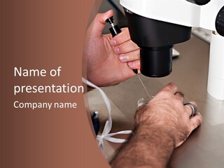 A Man Is Using A Microscope To Examine Something PowerPoint Template
