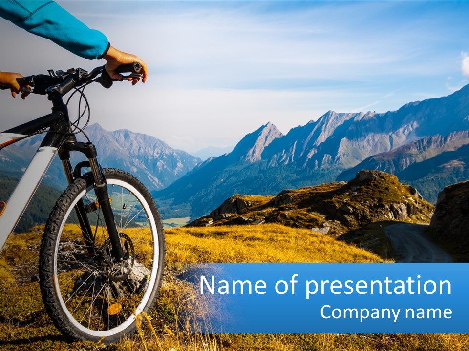 A Person Riding A Bike In The Mountains PowerPoint Template