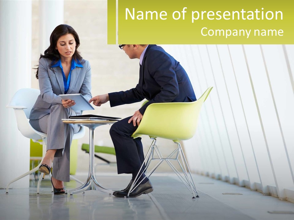 A Man And Woman Sitting At A Table With A Laptop PowerPoint Template
