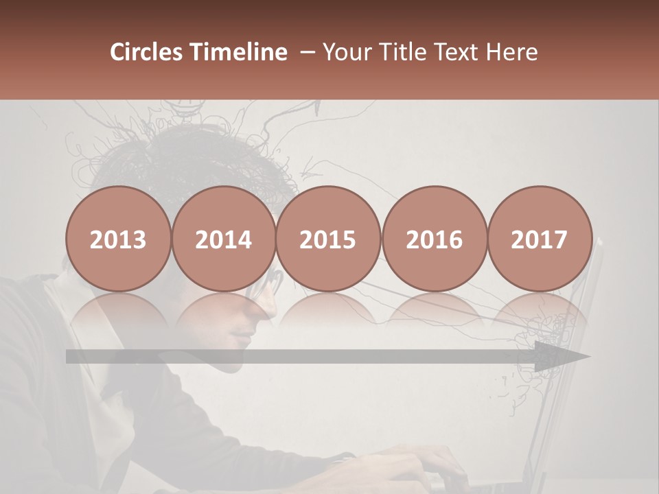 A Man Sitting At A Desk With A Laptop In Front Of His Head PowerPoint Template