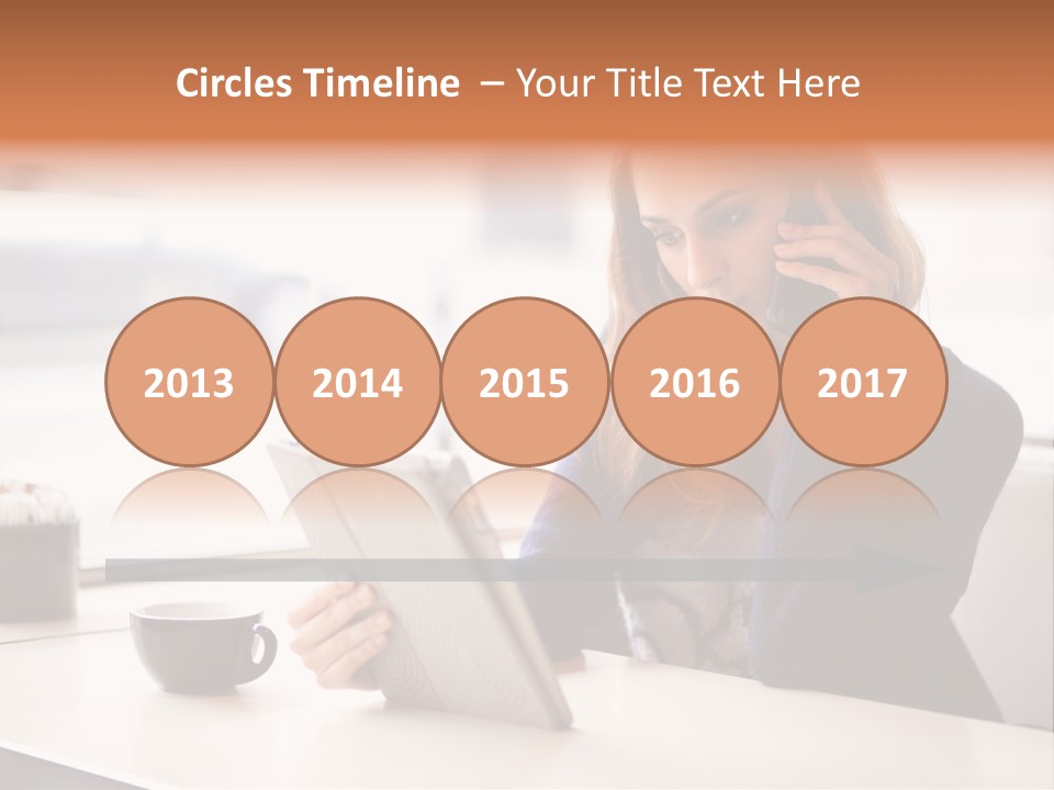 A Woman Sitting At A Table Talking On A Cell Phone PowerPoint Template