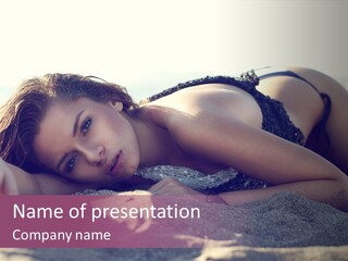 A Woman In A Bikini Laying On The Beach PowerPoint Template