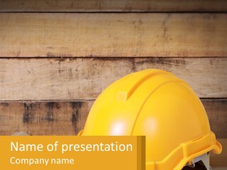A Yellow Hard Hat Sitting On Top Of A Wooden Table PowerPoint Template